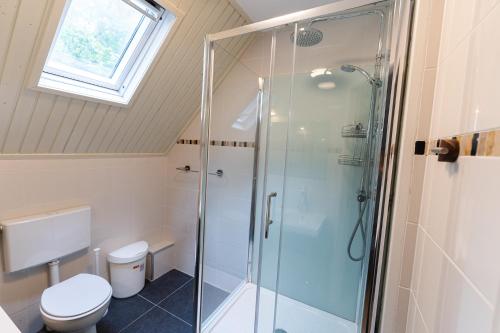 a bathroom with a shower and a toilet at 't Eekhoornnest in Soest