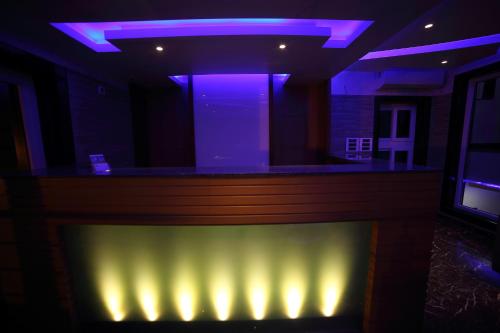 a bar with purple lights in a room at Vijaya Residency - Porur in Chennai
