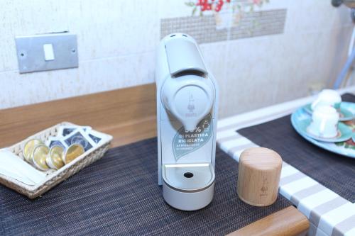 a electric hair drier on a table with a basket of food at Sotto La Rocca - Casa vacanze a 5 minuti dal mare in Cefalù