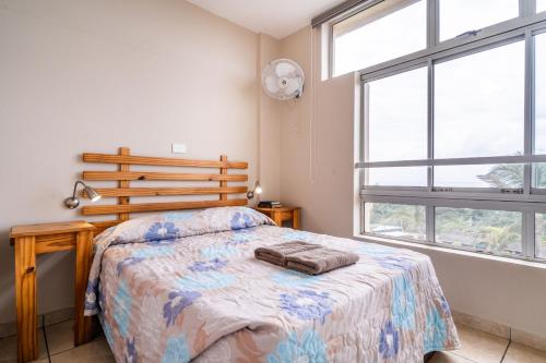 a bedroom with a bed and a large window at ATKV Natalia in Kingsburgh