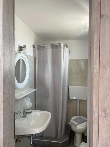 a bathroom with a sink and a toilet and a shower at Village Twins in Ios Chora