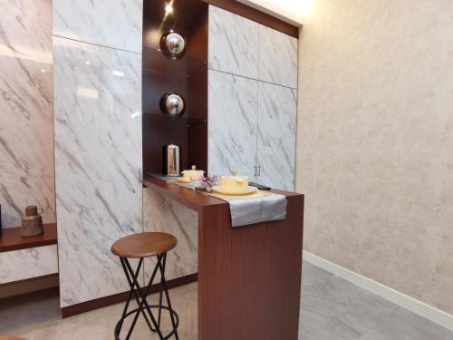 a bathroom with a counter and a stool in a room at Imperio Residence Melaka in Melaka