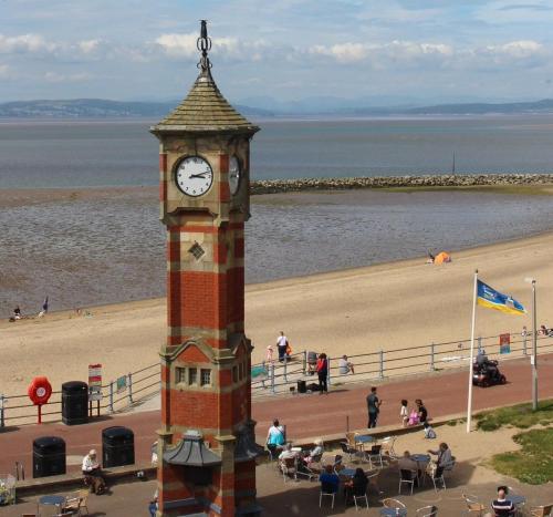a clock tower in front of a beach at Clock Tower Apartments 1 in Morecambe