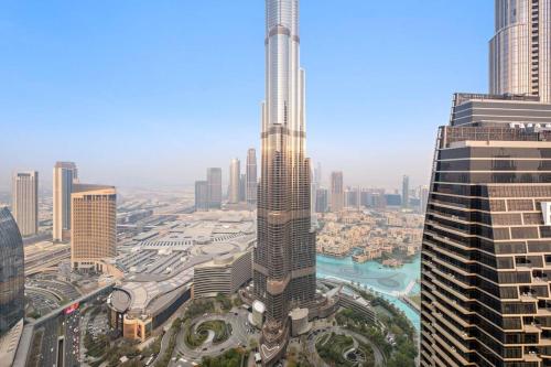 an aerial view of a city with a tall skyscraper at Luxury 4BR Flat, Downtown Dubai, Pool, Gym, PS5, Sleeps 11 Guests in Dubai