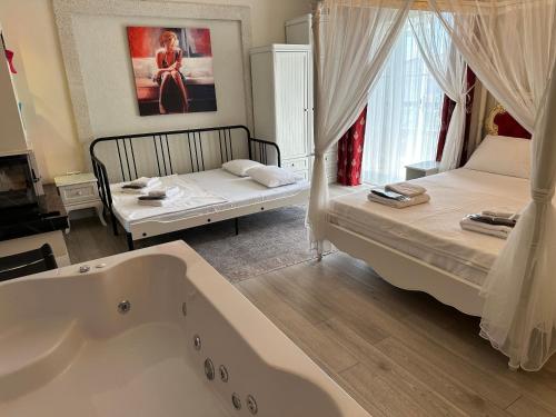 a bathroom with two beds and a bath tub at Grand Alaçatı Butik Hotel in Alacati