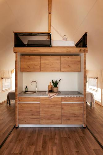 a kitchen in a tiny house with a bunk bed at Wecamp San Sebastián in San Sebastián