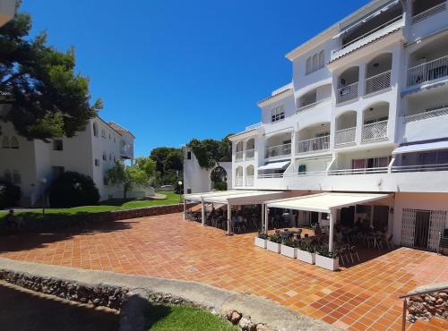 a large white building with a patio in front of it at APCOSTAS - Complejo Al Andalus in Alcossebre