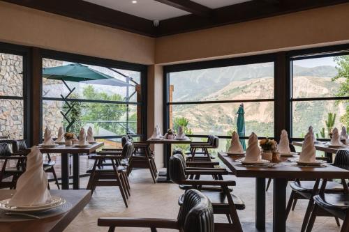 a restaurant with tables and chairs with cones on them at Burchmulla Resorts in Burchmulla