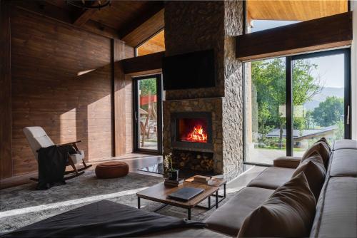 a living room with a couch and a fireplace at Burchmulla Resorts in Burchmulla
