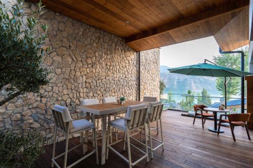 a dining room with a table and chairs and an umbrella at Burchmulla Resorts in Burchmulla