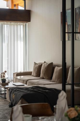 a living room with a couch and a window at Burchmulla Resorts in Burchmulla