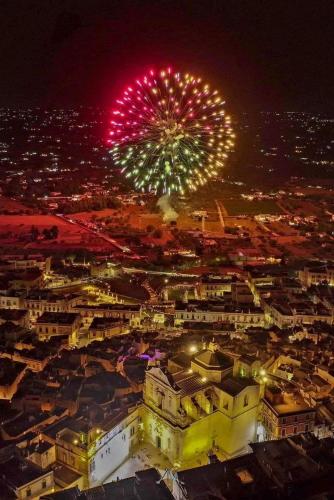 a fireworks display over a city at night at Balcone in Valle d'Itria in Martina Franca