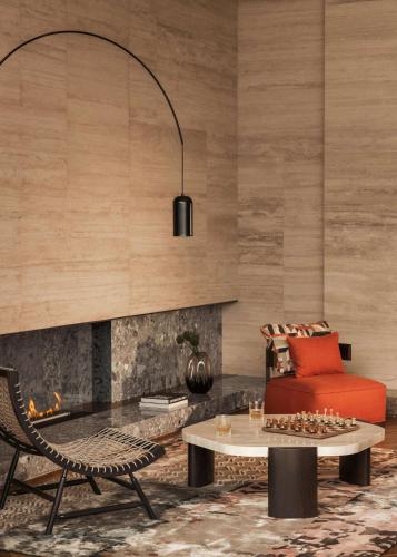a living room with a red couch and a table at One&Only Portonovi in Herceg-Novi