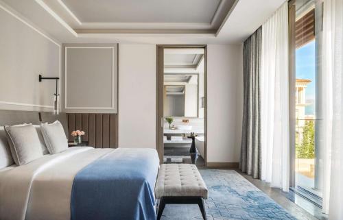 a bedroom with a bed and a large window at One&Only Portonovi in Herceg-Novi