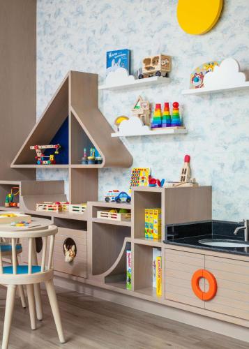 a childs play kitchen with a table and chairs at One&Only Portonovi in Herceg-Novi