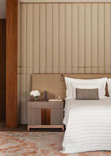 a bedroom with a bed and a table with flowers at One&Only Portonovi in Herceg-Novi