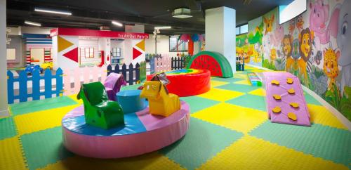 a childrens play room with colorful floors and toys at Caesar Blue Seaside Luxury Apartments in Kalecik