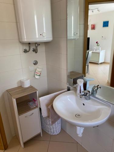 a bathroom with a sink and a toilet and a tub at Apartman Igor in Čižići