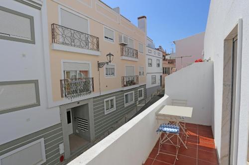 a balcony of a building with a desk on it at Casa da Flor in Lagos in Lagos
