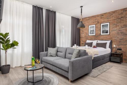 a living room with a bed and a couch at Mila apartments in Rijeka