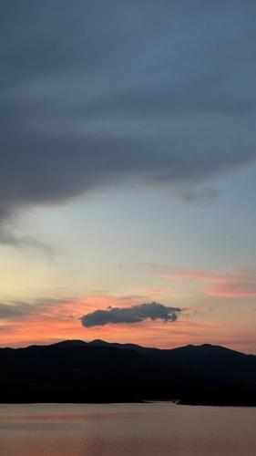 a sunset over a body of water with a sky at Lake house Zoya in Nikšić