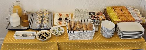 a table with plates and bowls and dishes on it at Beverley Dean - Children Over 5 Years Welcome - Continental Breakfast in Blackpool