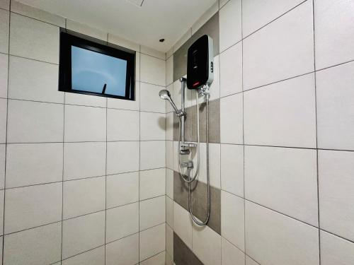 a shower in a bathroom with a tv on the wall at New The Sun Homestay at Sg Nibong nearby Queensbay or PISA or FTZ Bayan Lepas HENG in Bayan Lepas