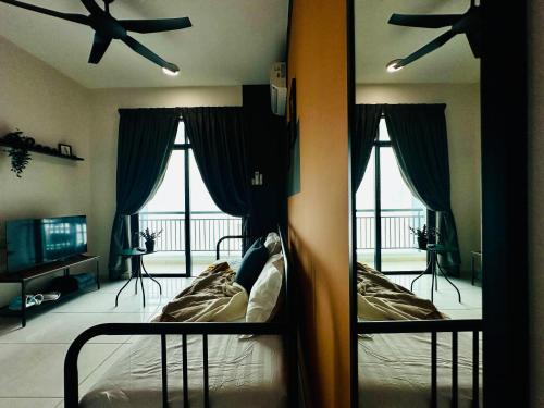 a bedroom with a bed and a mirror and a fan at New The Sun Homestay at Sg Nibong nearby Queensbay or PISA or FTZ Bayan Lepas HENG in Bayan Lepas