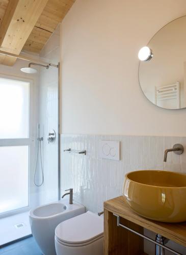 a bathroom with a tub and a toilet and a sink at la Sfiora B&B in Cervia
