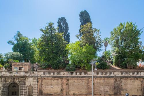 an old brick wall with trees behind it at 163 BOUTIQUE HOTEL in Rome