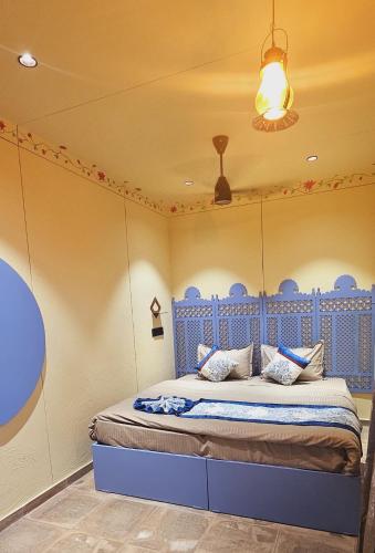 a bedroom with a blue bed in a room at The Village Resort in Kodāe
