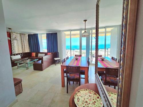 a dining room and living room with a view of the ocean at Villa La Tagora with Private Pool in Adeje