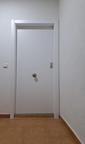 a white door in a room with a wooden floor at Apartamento El Cortijo in Ateca
