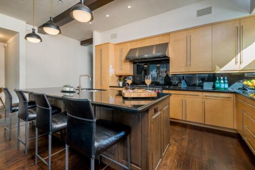a kitchen with a large island with bar chairs at East 5th St. 111 - 1 in Ketchum