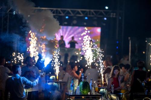 a group of people at a party with lights at Oz Hotels Sui in Alanya