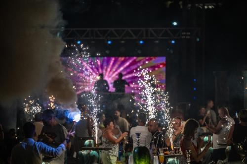 a crowd of people at a party at night at Oz Hotels Sui in Alanya