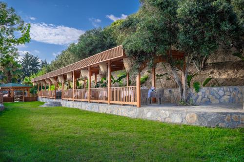 a house with a pavilion on a grass field at Oz Hotels Incekum Beach in Alanya