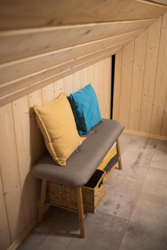 a bench with a pillow on top of a wall at Lesná Kokava in Kokava na Rimavica