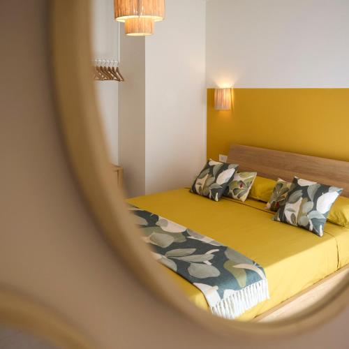 a reflection of a bedroom with two beds in a mirror at la Sfiora B&B in Cervia