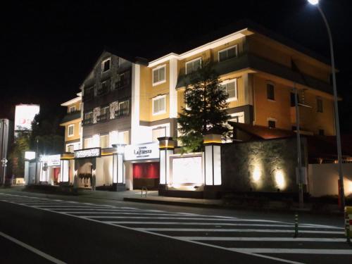 a building on the side of a street at night at Hotel La Siesta (Adult Only) in Kyoto