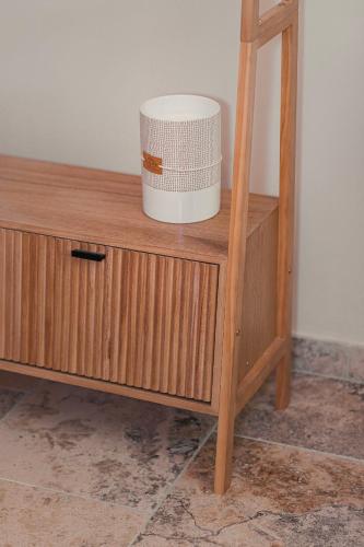 a wooden cabinet with a bucket on top of it at Les Suites de l'Étang in Cucuron