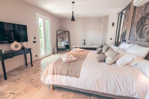 a bedroom with a large bed and a table at Les Suites de l'Étang in Cucuron