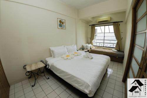 a bedroom with a bed with flowers on it at Nice Seaview Apartment with 2R1B in Port Dickson