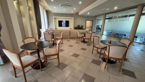 a restaurant with tables and chairs and a waiting room at Hotel Le Cerbaie in Altopascio