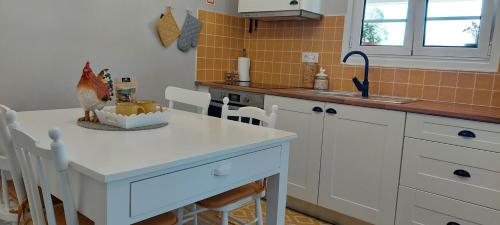 a kitchen with a white counter and a sink at Sete Cidades Quinta Da Queiró in Sete Cidades