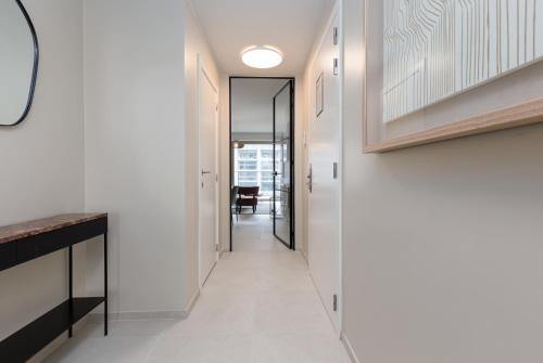 a hallway of a house with white walls at Sky Bridge Ostend - Casselbergh Residences in Ostend