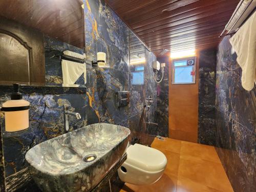 a bathroom with a sink and a toilet at Siddhant Hill Resort in Revadanda