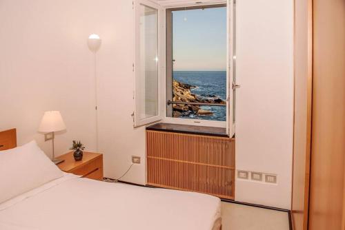 A bed or beds in a room at Carattino 12 Idyllic Seafront Retreat