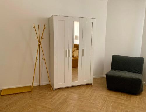 a room with a mirror and a chair in it at Bahama apartments in Bucsuháza