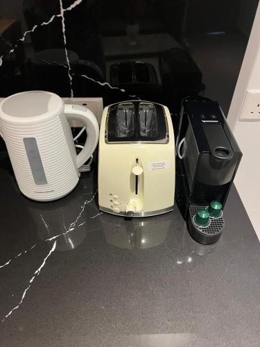 a toaster and a coffee maker sitting on a counter at Living Boutique Apartments Adults Only in Ayia Napa